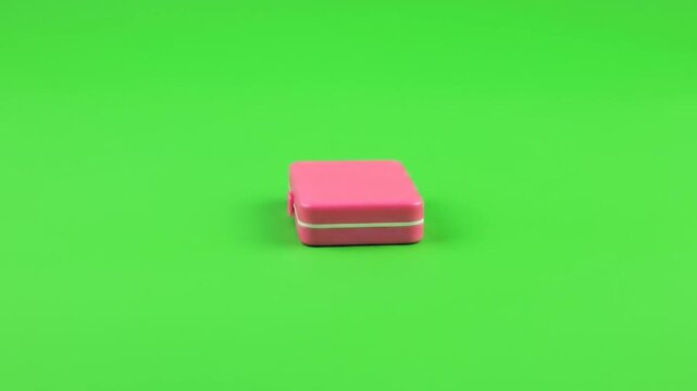 Green Screen Nature & Environment Pink erasers stacked and moved across a green surface
