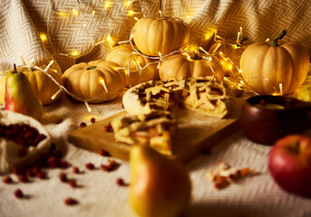 Cozy Autumn Thanksgiving Scene With Pumpkins, Pies, Apples, And Warm Fairy Lights