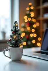 Festive home office setup with miniature Christmas tree, mug, and blurred golden lights