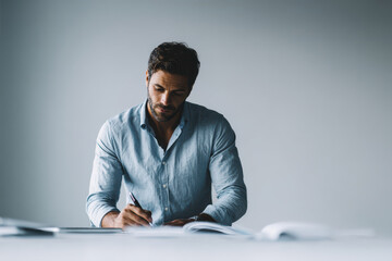 freelancer working intensely at clean desk surrounded by minimalist decor that emphasizes productivity