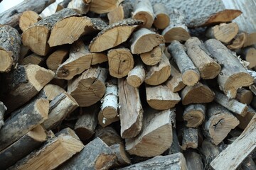 Fototapeta premium Pile of cut firewood outdoors, closeup view