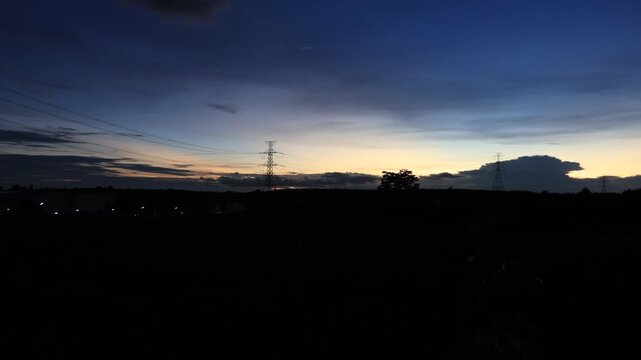 Natural video background of various trees growing along the edge of a large reservoir, with a cool breeze, colorful twilight sky, and the richness of the forest system.