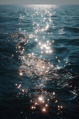 Glistening sunlight reflecting on calm ocean waves, creating a serene and tranquil atmosphere.
