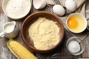 Making cornbread. Different ingredients and metal whisk on wooden table, flat lay