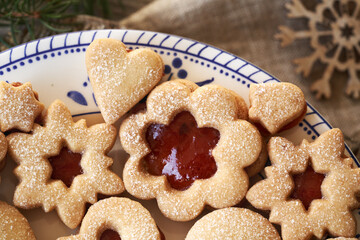 Traditonal Linzer Christmas cookies filled with strawberry marmalade and dusted with sugar