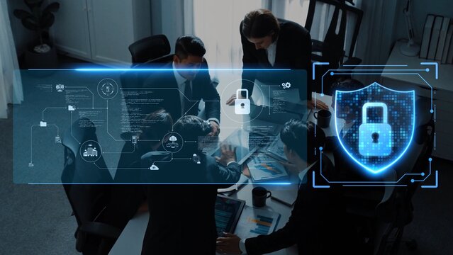 A business team collaborates on a cybersecurity strategy in a modern office. Digital visuals emphasize security, protection, and teamwork in a professional setting. Raster