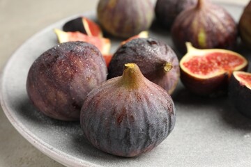 Whole and cut figs on table, closeup