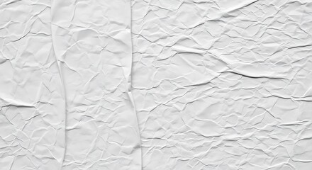 Close up of a textured white crumpled paper surface with deep shadows and highlights creating a dramatic abstract background