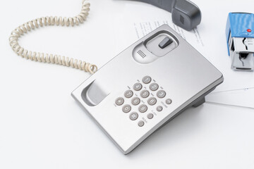 Office secretary uses telephone for communication during busy workday in modern workspace