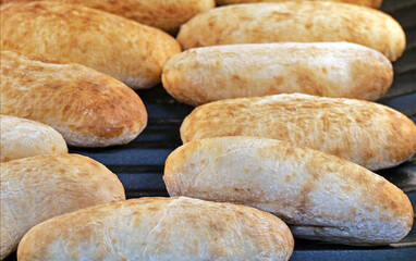Freshly baked ciabatta bread rolls - A Pile of Rustic White Bread Rolls in a Supermarket Bakery