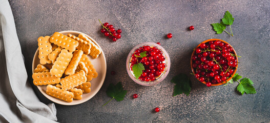 Traditional dessert with biscuit and red currant in a glass top view web banner