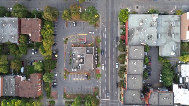 Aerial eagle view following Boulevard Rosemont in Montreal, showcasing calm and smooth traffic. Autumn colors create vibrant urban contrast.