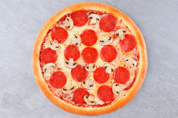 Pepperoni and Mushroom Pizza with Melted Cheese on Gray Stone Background