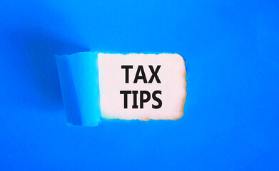 Tax tips symbol. Concept word Tax tips on beautiful white paper. Beautiful blue paper background. Business tax tips concept. Copy space.