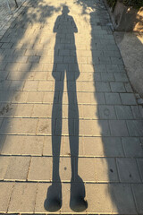 Photographer's shadow on asphalt