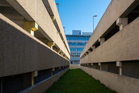 Symmetrical perspective between urban concrete blocks in Stockholm, minimalist architecture expressing rhythm, depth, composition and visual clarity for modern graphic background
