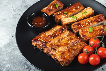 Closeup of pork ribs grilled with BBQ sauce and caramelized in honey.