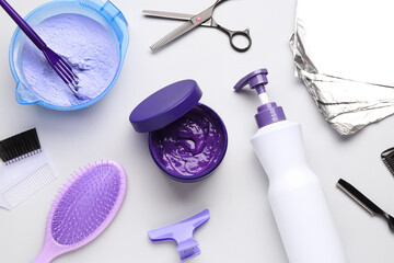Naklejka premium Hair care product for blonde hair and hairdresser's tools on white background, flat lay