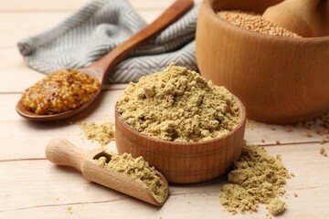 Different types of mustard on wooden table, closeup