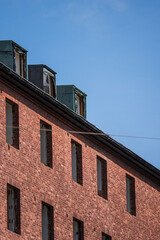 Red brick corner of abandoned upper building floors.