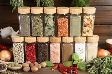 Different spices and jars on wooden table