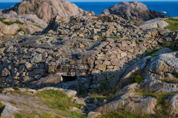 Rocky bunker camouflaged with stone by coast.