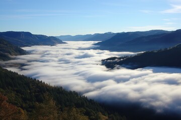 Serene valley shrouded in soft white clouds beneath blue sky mist mountains