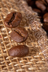 Close-up of coffee beans artfully arranged on a rustic burlap napkin