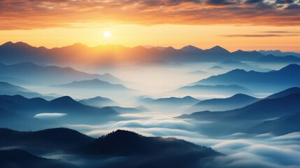 Golden sunrise over blue misty mountain ranges orange clouds