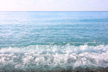 Beautiful view of wavy sea and pebbles on beach