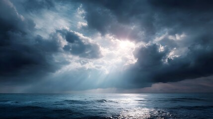 Sunlight rays pierce through dramatic storm clouds over the serene ocean