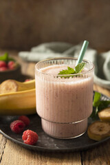 Refreshing banana raspberry smoothie with fresh mint for healthy living and summer enjoyment. Copy space.