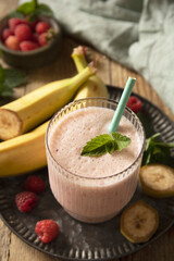 Refreshing banana raspberry smoothie with fresh mint for healthy living and summer enjoyment.