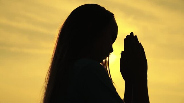 childhood dream of a happy childhood, silhouette of a teenager asking for help from God at sunset, praying for health at dawn, repenting of what he has done, faith in goodness and justice.