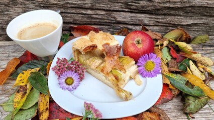 autumn still life with apple pie and leaves