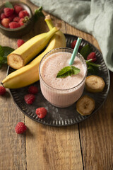 Refreshing banana raspberry smoothie with fresh mint for healthy living and summer enjoyment. Copy space.