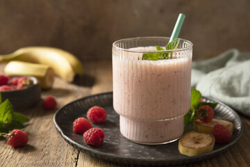 Refreshing banana raspberry smoothie with fresh mint for healthy living and summer enjoyment. Copy space.