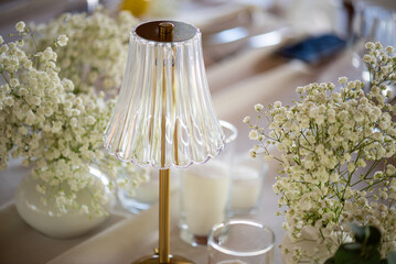 beautiful table setting with flowers and cutlery on wooden table at wedding or dinner. stylish tablewear decorations	