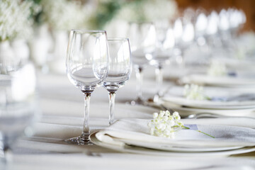 beautiful table setting with flowers and cutlery on wooden table at wedding or dinner. stylish tablewear decorations	