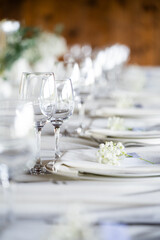 beautiful table setting with flowers and cutlery on wooden table at wedding or dinner. stylish tablewear decorations	