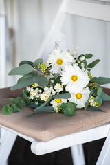 White floral bouquet with roses and daisies arranged in elegant vase for wedding table decoration, natural fresh flowers as romantic festive centerpiece for ceremony, celebration and reception event
