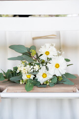 White floral bouquet with roses and daisies arranged in elegant vase for wedding table decoration, natural fresh flowers as romantic festive centerpiece for ceremony, celebration and reception event
