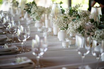 beautiful table setting with flowers and cutlery on wooden table at wedding or dinner. stylish tablewear decorations	