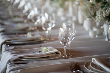 beautiful table setting with flowers and cutlery on wooden table at wedding or dinner. stylish tablewear decorations	