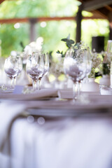 beautiful table setting with flowers and cutlery on wooden table at wedding or dinner. stylish tablewear decorations	
