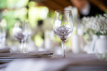 beautiful table setting with flowers and cutlery on wooden table at wedding or dinner. stylish tablewear decorations	