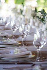beautiful table setting with flowers and cutlery on wooden table at wedding or dinner. stylish tablewear decorations	