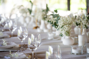 beautiful table setting with flowers and cutlery on wooden table at wedding or dinner. stylish tablewear decorations	