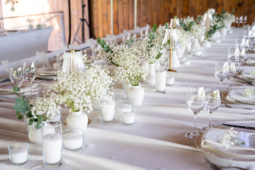 beautiful table setting with flowers and cutlery on wooden table at wedding or dinner. stylish tablewear decorations	