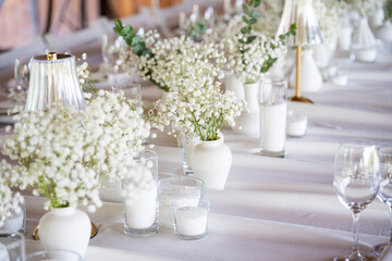 beautiful table setting with flowers and cutlery on wooden table at wedding or dinner. stylish tablewear decorations	